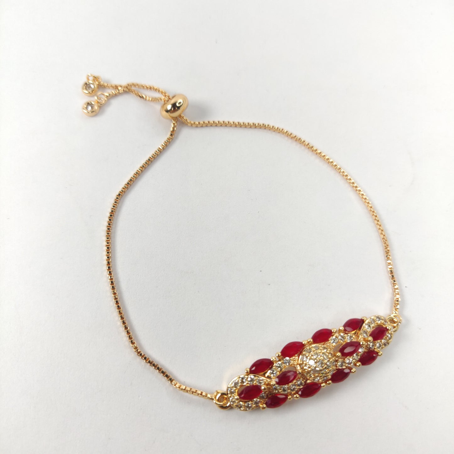 Gold Bracelet with Red and White Gem-Encrusted Pendant