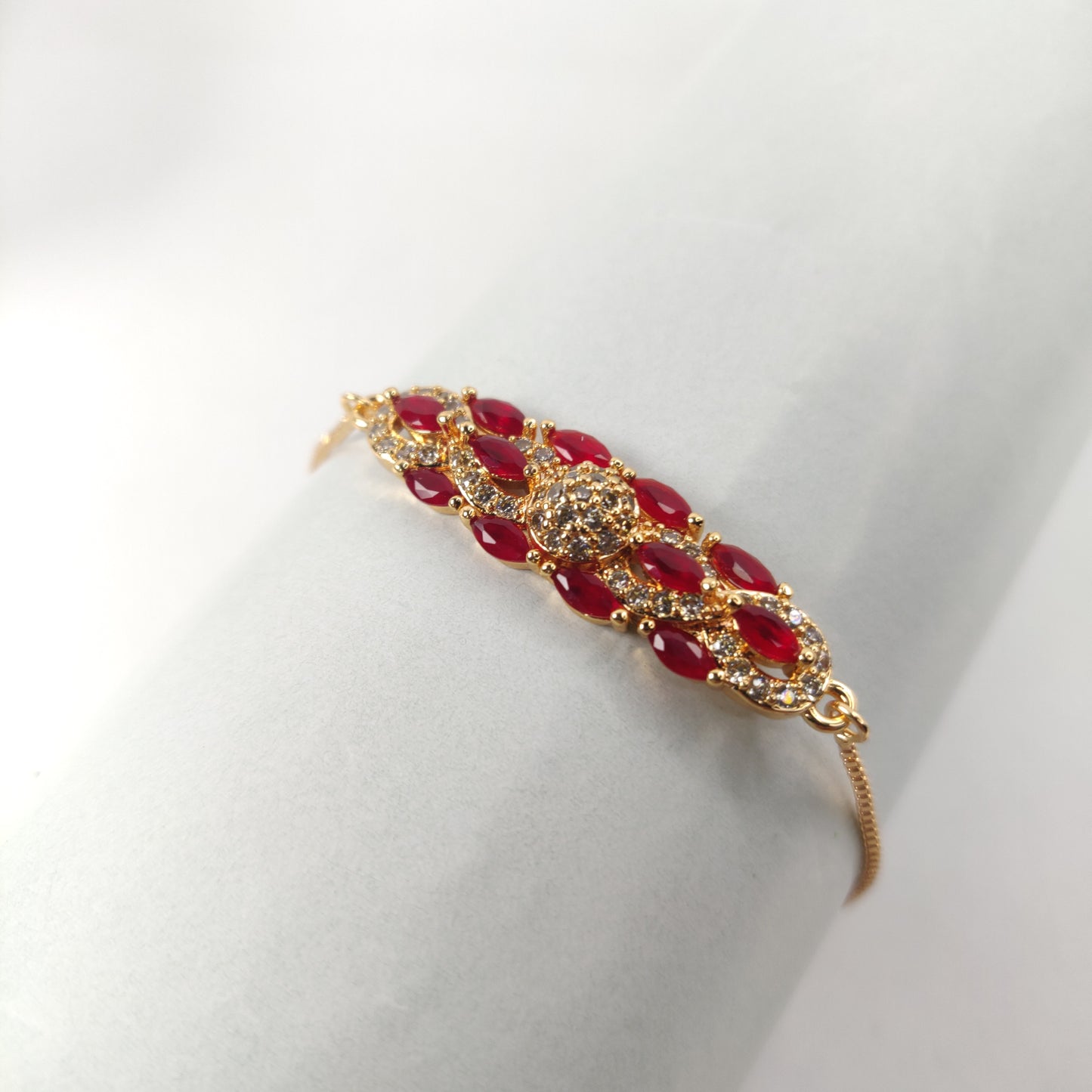 Gold Bracelet with Red and White Gem-Encrusted Pendant