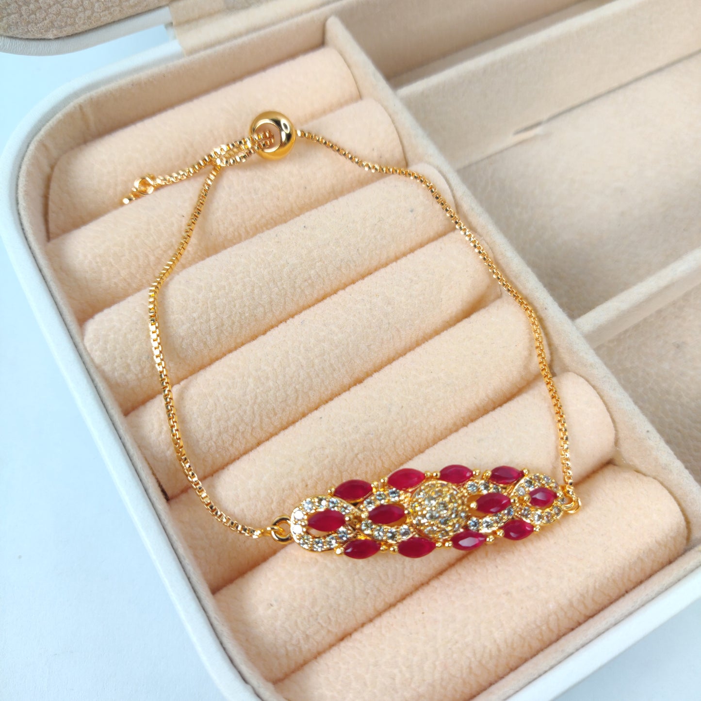 Gold Bracelet with Red and White Gem-Encrusted Pendant